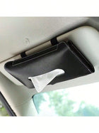 Car visor tissue holder with tissue on a car dashboard