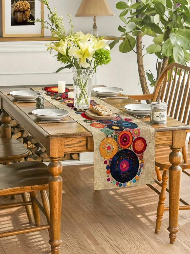 Dining table with a colorful table runner, plates, and a vase with flowers.